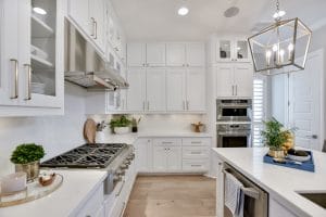 White kitchen with white cabinets marble and subway tile