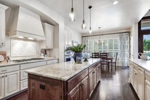 Classic white kitchen with white cabinets, River White granite and subway tile.