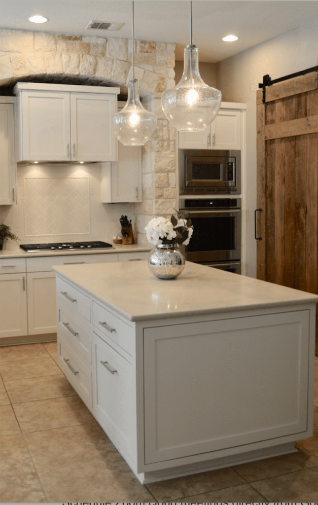 Kitchen remodel with Dreamy Marfil Caesarstone, white subway tile and barn door.